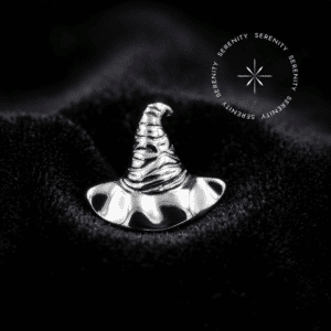 piercing titânio grau implante com design de chapéu repousando suavemente sobre um tecido de cetim branco de alta opulência.